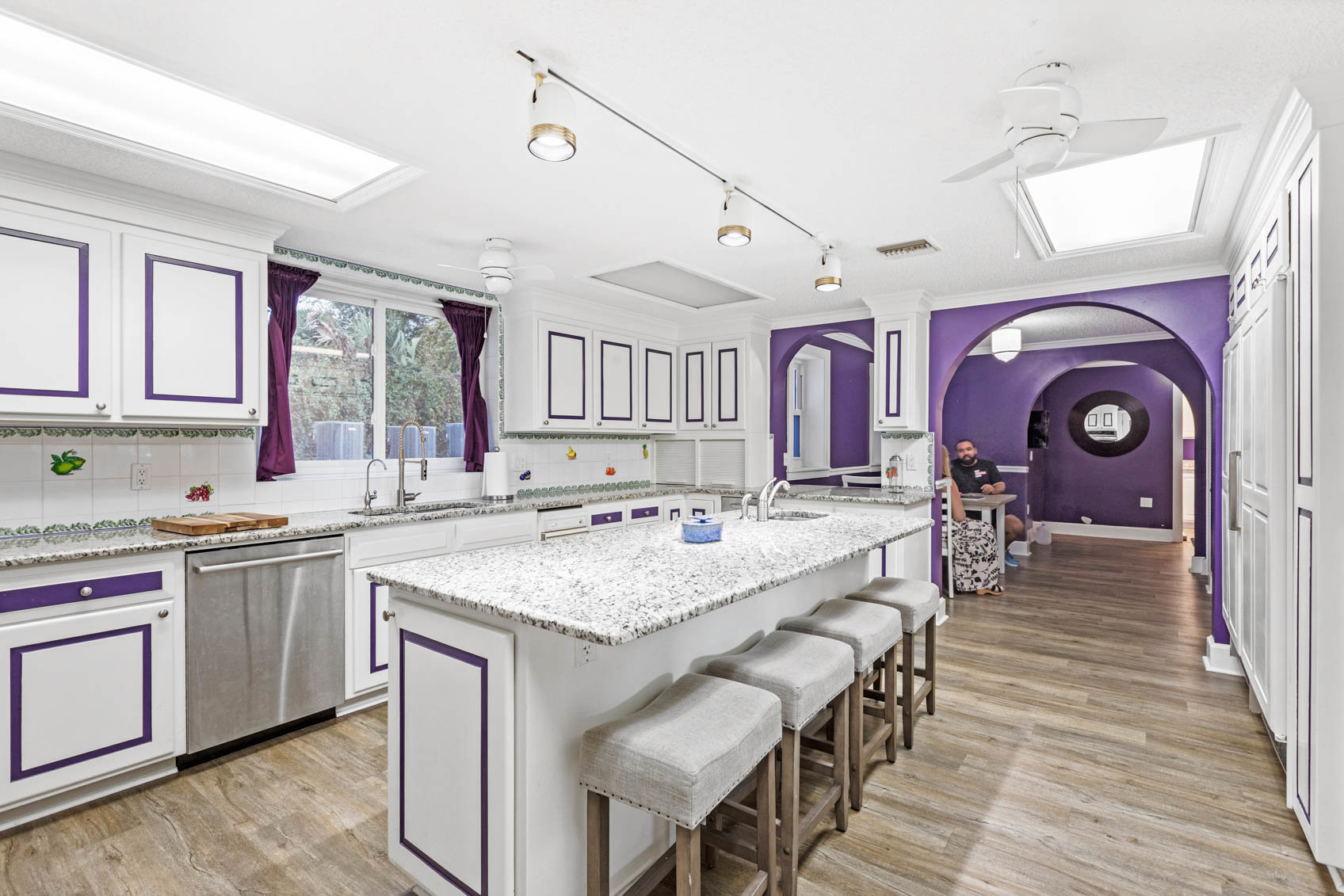 kitchen with purple hallway and white cabinets